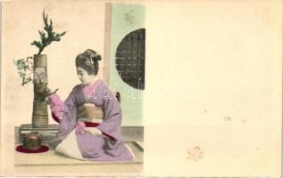 Japanese geisha with tea kettle