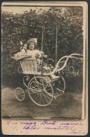 cca 1921 Kislány kutyájával gyerekhintóban, fotólap, 9x14 cm