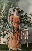 Lady in hat with a tree sapling (EK)