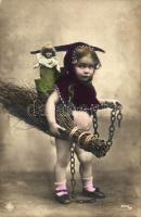 Child dressed as Krampus, with chains and whip