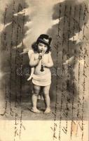 Child dressed as angel, with flute and soldiers hat (wet damage)