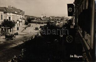 1940 Szászrégen, Reghin; tér, bevonulás, katonai teherautók, a Harmadik Birodalom zászlói / square, entry of the Hungarian troops, military trucks, Third Reich flags, 'Szászrégen visszatért' So. Stpl., photo (EK)