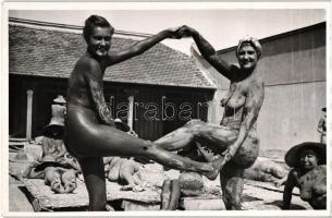 Sun and mud bathing nude women at the beach, photo