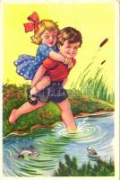 Boy and girl steps into a pond