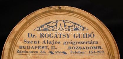 Rogátsy Guido Szent Alajos gyógyszertára (Bp. II. Rózsadomb) gyógyszeres doboza, d: 8,5 cm /

Medi...