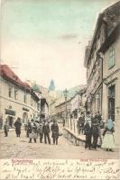 Selmecbánya, Schemnitz, Banska Stiavnica; Deák Ferenc utca, szálloda, vendéglő, üzletek. Kiadja Ernst Zsigmond / street, hotel, restaurant, shops (EK)