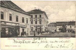 Marosvásárhely, Targu Mures; Fő tér, Bartscht Károly, Henning Károly, Csíky Emil, Falkenstein Ödön és Kohn József üzlete, Budapesti Ruharaktár. Petróczy G. kiadása / main square with shops