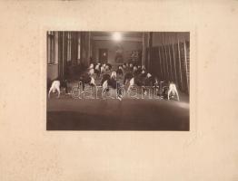 1928 Budapest, Tornaünnepély egy lányiskolában, az egyenruhán az iskola jelvényével, kartonra kasírozott, feliratozott, jelzett fotó, 11,5x16,5 cm