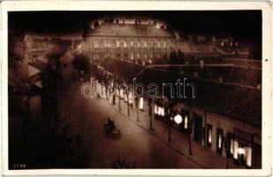 Komárom, Komárno; utcakép éjjel, üzletek / street view at night, shops, &#039;1938 Komárom visszatért&#039; So. Stpl. (EK)