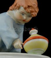 Zsolnay kisfiú a búgócsigával, fehér mázas, jelzett, hibátlan, m:11 cm, h: 14 cm (tervező:Sinkó Andr...