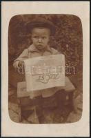 cca 1920-1930 Azt Est című újságot olvasó kisfiú, fotólap, 14x9 cm