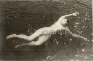 Erotic nude lady swimming. photo