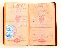 1965 Magyar Népköztársaság által kiállított fényképes szolgálati útlevél, benne sok afrikai és ázsiai pecséttel, ázott állapotban / Hungarian passport