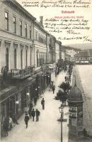 Kolozsvár, Cluj; Mátyás király tér, Takarékpénztár, Schuster Emil üzlete, hirdetőoszlop Turul cipő reklámmal / square, savings bank, shops, advertising column with shoe advertisement (EK)