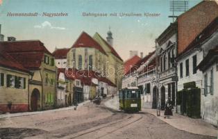 Nagyszeben, Hermannstadt, Sibiu; Vasút utca, Orsolya-rendi zárda, villamos, Fenig A. üzlete / Bahngasse, Ursulinen Kloster / street view with tram, nunnery and shops   (EK)