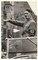 Der Führer und Reichskanzler des deutschen Volkes / Adolf Hitler in automobile with swastika armband