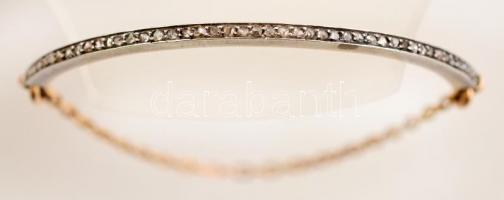 Ezüst(Ag) és arany(Au) 14K részekből álló női karkötő, apró kövekkel díszítve, jelzett, bruttó: 6,7 ...