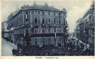 Susak, Sansego; Trumbicev trg / square with celebrating crowd and Croatian flags (fl)