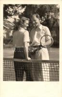 Couple playing tennis. Amag 67811.