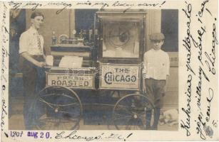 1907 The Chicago Fresh Roasted. American popcorn popper machine with vendors. photo