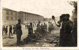 Greek soldiers roasting meat on the street. photo