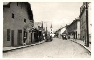 Maroshévíz, Toplita; utca és református templom, patika, fodrász / street view with Calvinist church, automobiles, hairdresser, pharmacy