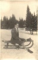 Winter sport, man sitting on a sled. photo (fl)