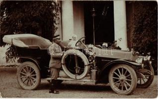 1913 Vintage automobile with a baby, driver with a spare tire. photo (EK)