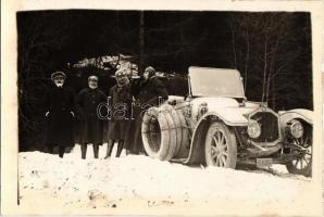 Vintage De Dion-Bouton automobile in winter, four spare tires. photo