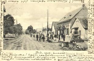 1904 Bia, Biatorbágy; Fő utca, kerekes kút, Szabó J. Gyula vegyeskereskedése és saját kiadása (EK)