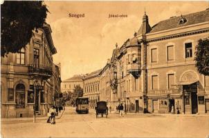 1911 Szeged, Jókai utca, Merkler Á. Hermann üzlete, Szegedi gőzmalom lisztraktára, Schicht szappan reklámja, villamos. Kiadja Bartos Lipót (fa)
