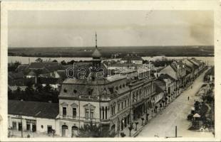 1943 Zenta, Senta; látkép a Tisza felé, Lócy László, Bakay János üzlete, Erzsébet szalon, Auto Garage garázs, felrobbantott Tisza híd roncsai a távolban. Kiadja Özv. Molnár Sz. Vincéné / general view, shops, salon, automobile garage, wreckage of the blown-up bridge  (fl)