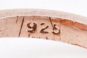 Ezüst(Ag) aranyozott gyűrű, fekete és fehér kövekkel, jelzett, méret: 55, bruttó: 4,9 g