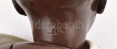 Fekete műanyag baba, ruhában, tarkóján K jelzéssel, kopásnyomokkal, m: 35 cm