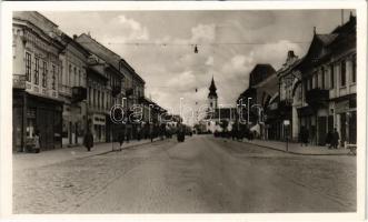 1941 Zombor, Sombor; Fő utca, Meinl, Müller üzlete, magyar zászlók / main street, shops, Hungarian flags + "1941 Zombor visszatért" So. Stpl. (ragasztónyom / glue mark)