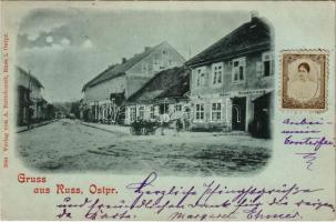 1899 Rusné, Russ, Ruß (Ostpreußen); street view, Hotel Niederung, shop, horse-drawn carriage. Verlag von A. Buttchereit 2044. Photo of a lady glued to postcard