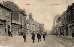 1910 Miskolc, Fő utca, villamos, üzletek. Grünwald Ignác kiadása + POPRÁD - MISKOLCZ 288. SZ. A vasúti mozgóposta bélyegző (EK)