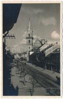 Beszterce, Bistritz, Bistrita; utca, üzletek, templom / street view, shops, church. photo