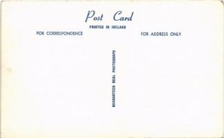 Tipperary (?), Street, shops, automobiles. photo