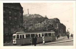 Budapest XI. Szent Gellért tér, Szabadság szobor, Gellért szálló és barlangtemplom a háttérben, 18-as villamosok, automobil. photo