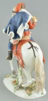 Meissen. Huszár. Egy előretörő fehér lovat egy szőrmekarimás sapkában és kék köpenyben lovagló huszá...