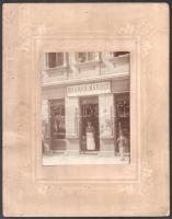cca 1900 Baumann Károly mészáros és hentes üzlete, utcai front, kartonra kasírozott fotó, a karton kissé sérült, ázott, 14,5x11,5 cm, karton méret: 28x22 cm