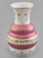 Zsolnay váza, porcelán, rózsaszín irizáló réteggel és aranyozott virágmotívumokkal, jelzett: arany, öttemplom és három pajzs, belül két sorban ZSOLNAY PÉCS felirat. 1926-1930 körül. Repedt, kopott. m: 14 cm