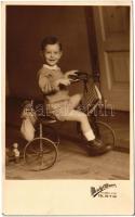 Kisgyerek triciklin. Mosoly Albuma / Little boy on tricycles. photo