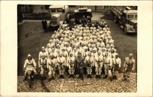 ~1940 Debreceni Légoltalmi csapat katonái védőruhában autógépjárművek előtt / Hungarian military air defense unit in protective clothing, automobiles, trucks. photo (fl)