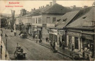 1910 Kolozsvár, Cluj; Wesselényi Miklós utca, Fuhrmann Károly fűszerkereskedése, Kádár Endre, Hübschmann M., Gráf József, Ellek I., Kádár Endre, Cipő nagy raktár, Hirsch Adolf üzlete, magyar zászló. Újhelyi és Boros kiadása / street view, shops, Hungarian flag