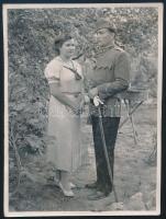 1938 Katona kedvesével, egyenruhában, bocskai sapkával, karddal; fotó, a hátoldalon feliratozott, ragasztásnyomokkal, 11x8,5 cm