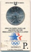 Amerikai Egyesült Államok 1984P 1$ Ag "XXIII. Nyári Olimpiai Játékok, Los Angeles" eredeti, sorszámozott karton díszcsomagolásban T:BU patina, a csomagolás kissé kopott USA 1984P 1 Dollar Ag "Los Angeles XXIII Olympiad" in original, serial numbered cardboard decorative packaging C:BU patina, the packing slightly worn Krause KM#210