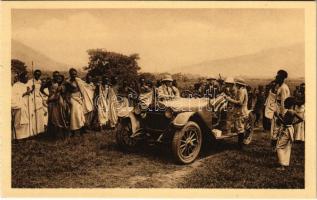 Preparations for the departure. Vintage automobile on Rwanda, African folklore, natives (from postcard booklet)