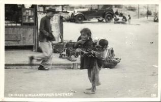Chinese girl carries her brother photo